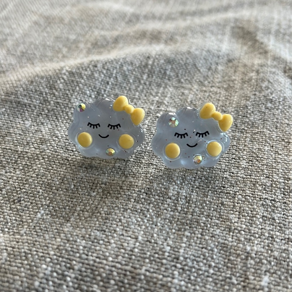 Blue smiling cloud post earrings with yellow bow and rhinestones